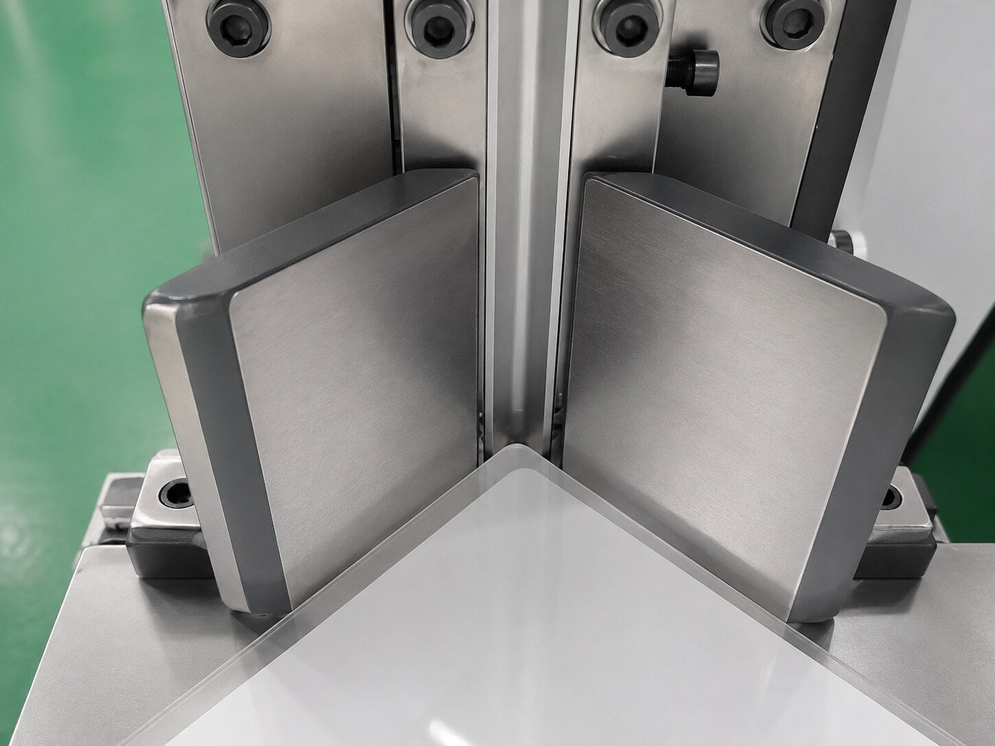 Clean stainless-steel corner die finishing a rounded clear laminating pouch corner