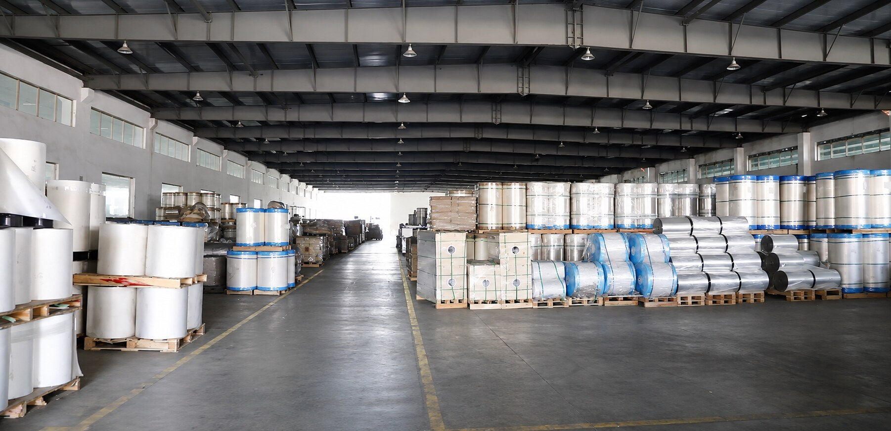 Organized JIWEN warehouse with film rolls and palletized inventory